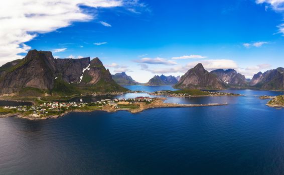 Aerial panorama of Reine fishing village surrounded by high mountains on Lofoten islands in Norway.