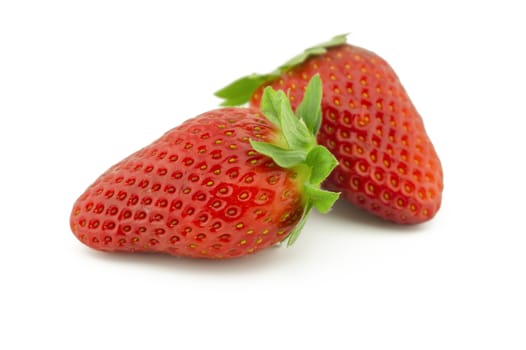 Two whole juicy ripe strawberries fruits isolated on white background