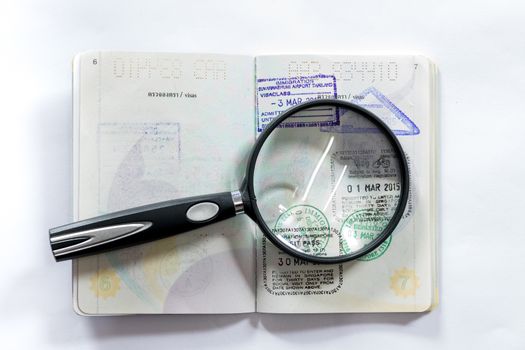 Magnifying glass placed over the page with the seal of the city of passports of different countries.