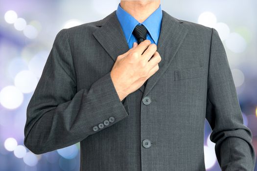 Young businessman Wearing a blue shirt, black tie and then covered with a gray suit.