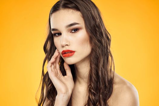 Woman with bare shoulders red cropped lips charm yellow background. High quality photo