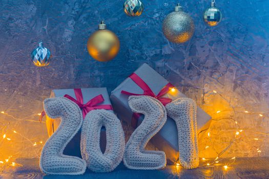 New year's holiday composition with crochet numbers 2021 gift box, and garland decor