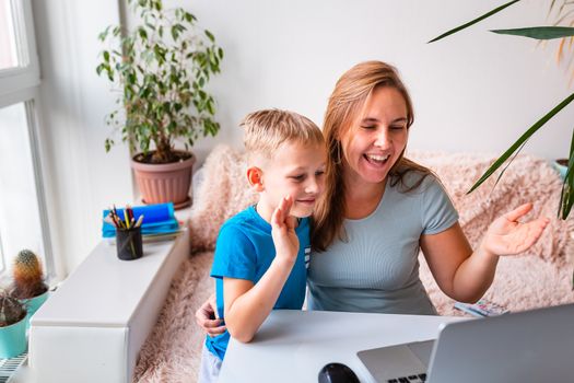 Mother with kid trying to work from home during quarantine. Stay at home, work from home concept during coronavirus pandemic