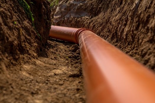Plastic pipes in the ground during the construction of a building.