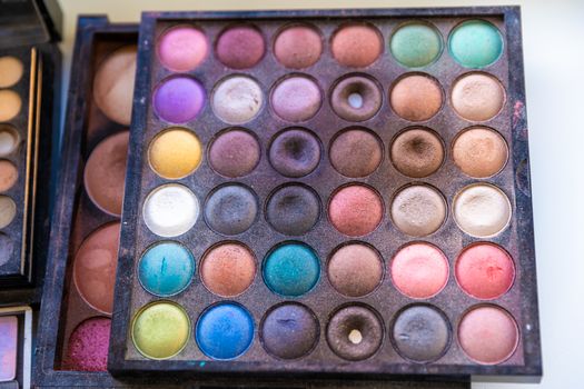 palette with colorful make-up on the table of a make-up artist.