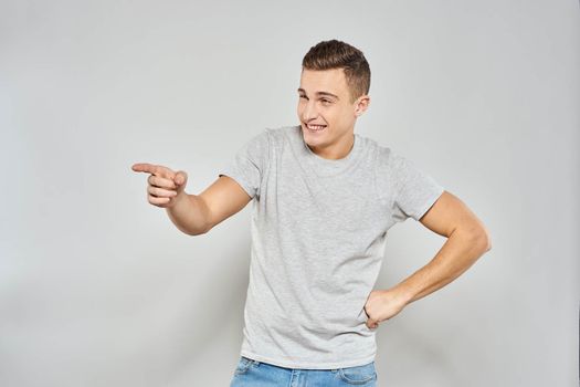 handsome man in light t-shirt cropped view emotion studio isolated background. High quality photo