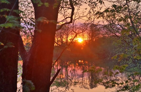 Beautiful and romantic sunset at a lake in stunning yellow and orange colors