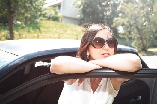 Smiling female driver looking out the car