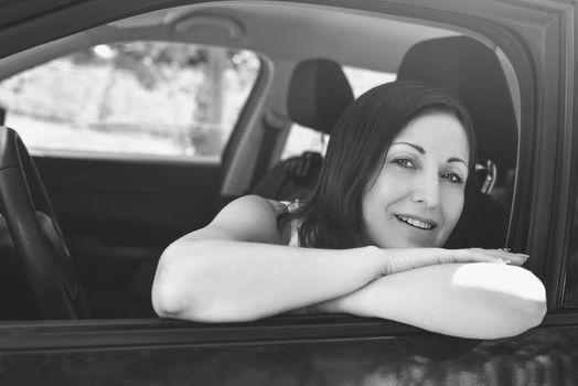 Smiling female driver looking out the car