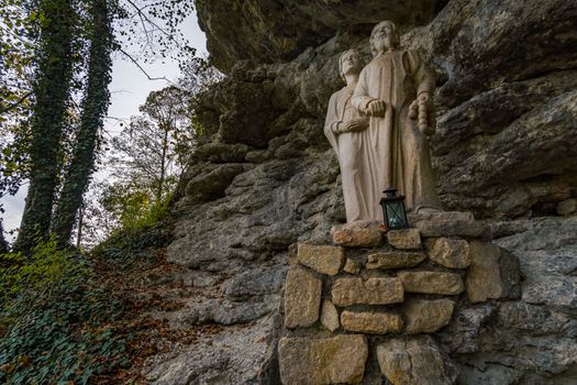 Holy stone statue in the Brother Klaus Grotto a pilgrimage site at Beuron Monastery in the Danube Valley in autumn