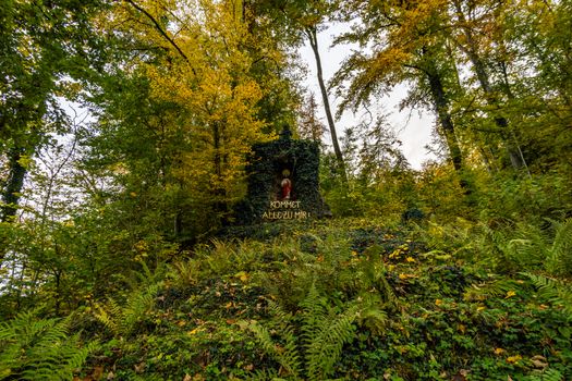 Holy stone statue in the Brother Klaus Grotto a pilgrimage site at Beuron Monastery in the Danube Valley in autumn