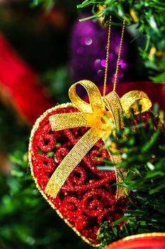 Christmas hanging decorations on fir tree. Decorated Christmas tree. Fir branch with Christmas baubles decorations.