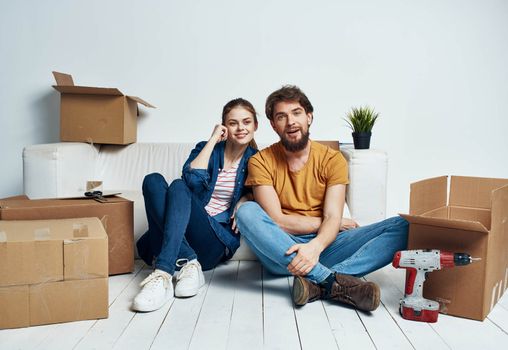 A man and a woman with boxes are moving. Well, an apartment is being renovated by a family. High quality photo