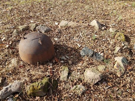 rocks and rusty iron metal cauldron in a circle