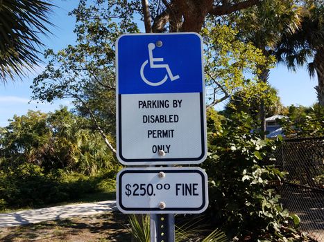 parking by disabled permit only sign with 250 dollar fine