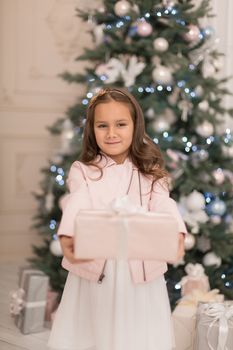 Happy childhood, magical Christmas tale. Little princess with Santa's present for Christmas.