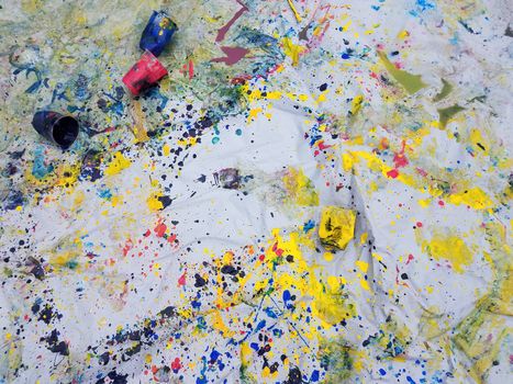 colorful mess of paint splatter with plastic cups