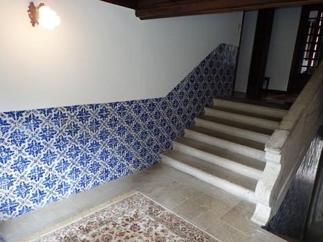 cement steps or stairs with blue tiles on the wall