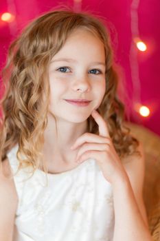 .Portrait of a cute girl on the background of Christmas garlands.