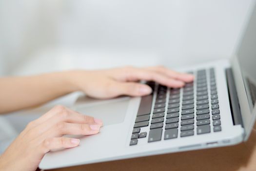 Closeup young asian woman using laptop for leisure on bedroom, girl working online with notebook freelance, business concept.