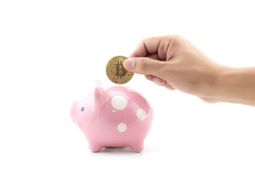 Saving golden bitcoin in piggy bank with hand isolated on white background, Digital currency money trading with cryptocurrency, coin with profit, finance concept.