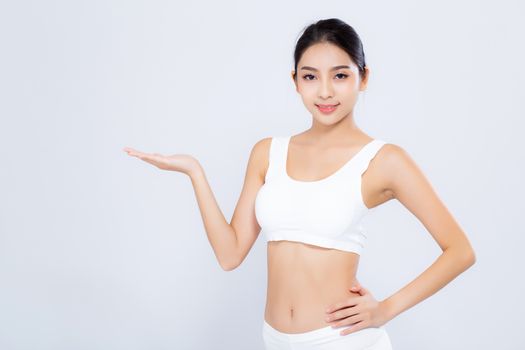 Portrait young asian woman smiling beautiful body diet with fit presenting something empty copy space on the hand isolated on white background, model girl weight slim with cellulite or calories, health and wellness concept.