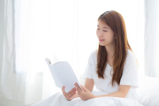 Beautiful of portrait young asian woman relax sitting reading book on bedroom at home, girl study literature, education and llifestyle concept.