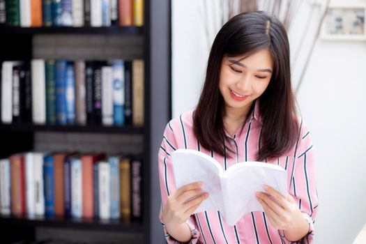 Beautiful of portrait young asian woman relax sitting reading book in living room at home, girl study literature, education and llifestyle concept.