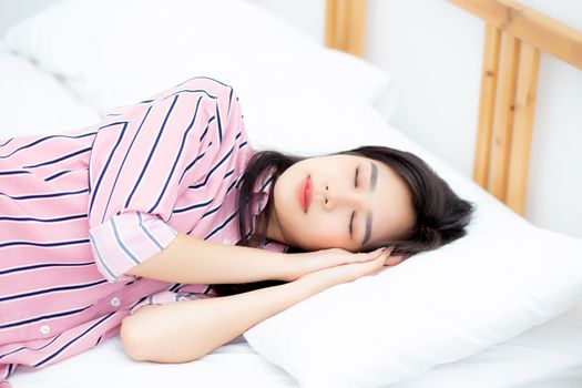 Portrait of beautiful asian young woman sleep lying in bed with head on pillow comfortable and happy with leisure, girl with relax  for health and lifestyle concept.
