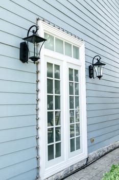 Vintage wall lamp on wooden wall.