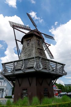 Old vintage wind turbine on blue sky background.