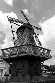 Old vintage wind turbine on blue sky background.