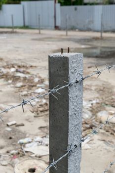 wire with clusters of short, sharp spikes set at intervals along it, used to make fences or in warfare as an obstruction.