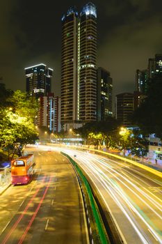 Car lights at night in Singapore city.