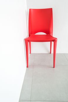 The red chair on the white.