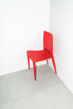 The red chair on the white.