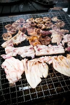 Grilled pork on the grill iron using charcoal fire.