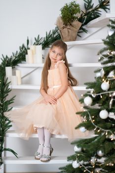 Little girl in princess dress celebrates christmas. Christmas magic fairy tale. Happy childhood.