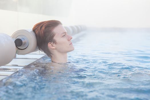 winter pool with a young attractive relaxing woman.