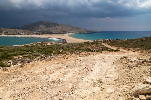 Scenic view from peninsula Prasonisi on Rhodes island, Greece with the aegean see on the right and the mediterranean see on the left side with dark sky before a thunderstorm