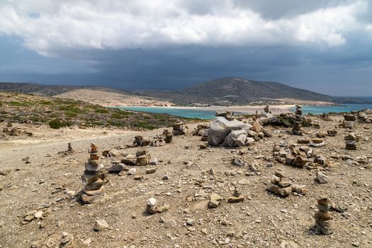 Scenic view from peninsula Prasonisi on Rhodes island, Greece with the aegean see on the right and the mediterranean see on the left side with dark sky before a thunderstorm