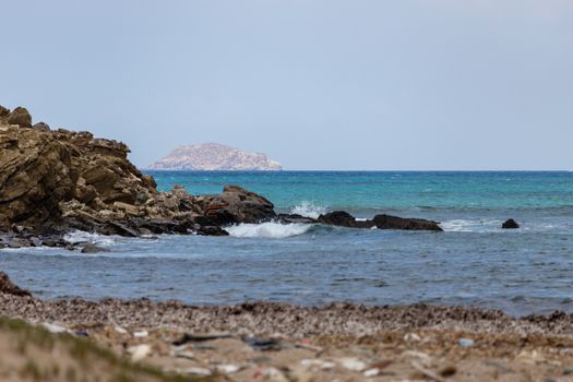 Coastline with rock formations protruding into the sea on the Prasonisi peninsula on the Greek island of Rhodes