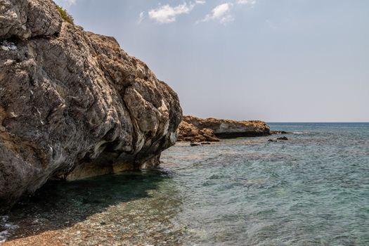Rocky coastline at the beach of Kiotari on Rhodes island, Greece in summer at a sunny day
