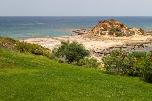 Scenic view at the coastline of Kiotari on Rhodes island, Greece with gravel beach and rocks in the water