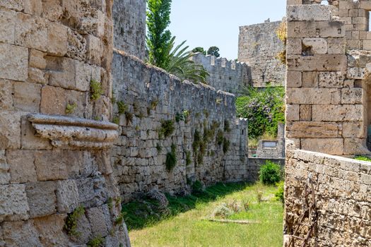 Part of the antique city wall with ditch in the old town of Rhodes city on Greek island Rhodes