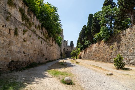 Along the ditch of the antique city wall in the old town of Rhodes city at greek island Rhodes on a sunny day in summer