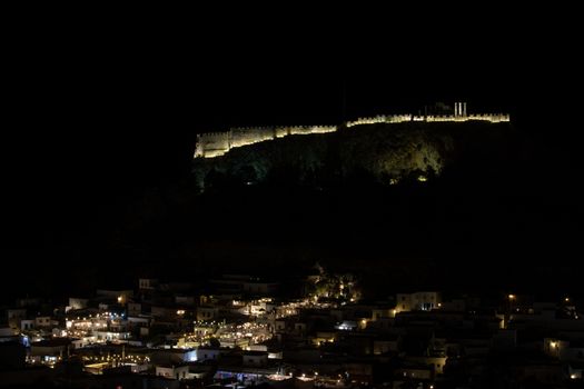 View at the illuminated city of Lindos and the acropolis on Greek island Rhodes by night