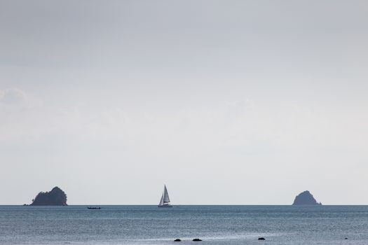 Krabi Thailand 12.16.2015 looking out to sea with sailing boat on horizon between two islands. High quality photo