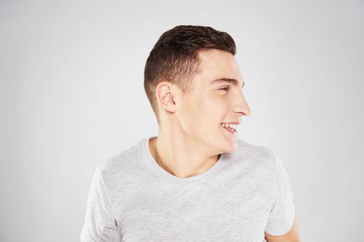 Emotional man in white t-shirt cropped view on blue background lifestyle. High quality photo