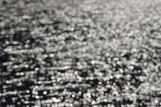 3 - Graduated light to dark bokeh, formed from water ripples and sunlight, giving an abstract textured monochrome background, black and white.
